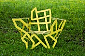 LA NORIA  FRANCE. GARDEN DESIGNED BY ARNAUD MAURIERES AND ERIC OSSART - SCULPTURES IN THE PRAIRIE DE SCULPTURES YELLOW METAL CHAIR