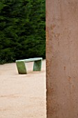 LA NORIA  FRANCE. GARDEN DESIGNED BY ARNAUD MAURIERES AND ERIC OSSART - CONCRETE WALL AND GREEN BENCH BESIDE THE GARDEN ENTRANCE - A PLACE TO SIT