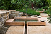 LA NORIA  FRANCE. GARDEN DESIGNED BY ARNAUD MAURIERES AND ERIC OSSART - THE ALLEE DES CYPRES - THE ISLAMIC STYLE WATER GARDEN - RILL LEADING TO WATER BASIN AND STONE FOUNTAIN