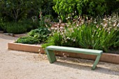 LA NORIA  FRANCE. GARDEN DESIGNED BY ARNAUD MAURIERES AND ERIC OSSART - GREEN CONCRETE BENCH AND BORDER OF GAURA