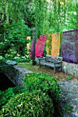 JARDIN DES SAMBUCS  FRANCE - THE STONE BRIDGE WITH MULTI-COLOURED CURTAINS AND WOODEN BENCH