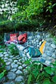 JARDIN DES SAMBUCS  FRANCE - RIVER COBBLED BENCH WITH SOFT CUSHIONS FOR SIESTAS IN SHADE