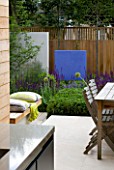 DESIGNER: CHARLOTTE ROWE  LONDON: FORMAL TOWN/CITY GARDEN WITH BLUE FEATURE WALL AND FENCE/TRELLIS AND PERENNIAL PLANTING