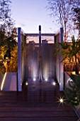 CONTEMPORARY FORMAL ROOF TERRACE/ GARDEN DESIGNED BY DATA NATURE ASSOCIATES: MODERN METAL SHOWER LIT AT NIGHT WITH METAL BEAD SCREEN AND DECKING