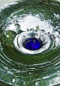 DAVID HARBER SUNDIALS: CLOSE UP OF SWIRLING WATER AT THE CENTRE OF VORTEX WATER FEATURE