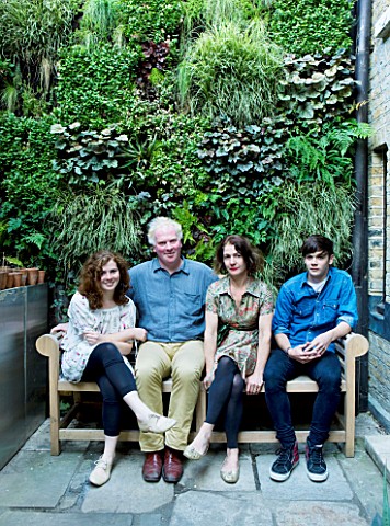 CHRIS_DYSON_AND_FAMILY_SIT_ON_A_SEAT_IN_FRONT_OF_THE_GREEN_LIVING_WALL