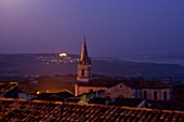 PROVENCE  FRANCE: BONNIEUX CHURCH IN M OONLIGHT WITH LACOSTE BEYOND