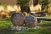 PROVENCE  FRANCE: DOMAINE DE LA VERRIERE: A PLACE TO SIT- A CIRCLE OF WOODEN BENCHES BY MARC NUCERA IN WOODLAND WITH STIUPA TENUISSIMA AND WOODEN BALL SCULPTURE ALSO BY MARC NUCERA