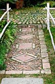 GARDEN OF ERIK BORJA  FRANCE: JAPANESE/ ASIAN STYLE - PATH OF BRICKS AND STONE WITH BAMBOO EDGING