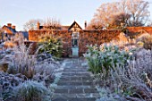 WOLLERTON OLD HALL  SHROPSHIRE: WINTER GARDEN IN FROST -  PATH TO THE HOUSE AT DAWN WITH CLIPPED BEECH HEDGE AND FROSTY BORDERS