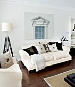 CHRISTMAS - LIVING ROOM WITH CREAM SOFAS  CUSHIONS AND TRIPOD LAMP. SARAH EASTEL LOCATIONS/ DI ABLEWHITE