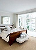 CHRISTMAS - MASTER BEDROOM MWITH LARGE WOODEN DOUBLE BED AND WRAPPED PRESENTS.  SARAH EASTEL LOCATIONS/ DI ABLEWHITE