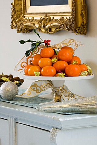 CLARE_MATTHEWS_CHRISTMAS_HOUSE_INTERIOR_DRESSER_WITH_OIL_PAINTING__ORANGES__GRAPES_AND_NUTS_IN_BOWLS