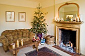 CLARE MATTHEWS CHRISTMAS HOUSE INTERIOR: THE LIVING ROOM - FIREPLACE  SETTEE  WOODEN TABLE AND CHRISTMAS TREE