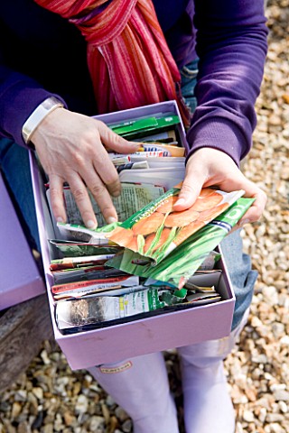 DESIGNER_CLARE_MATTHEWS__POTAGER_PROJECT__CLARE_HOLDS_BOX_OF_SEEDS_IN_SEED_PACKETS