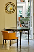 DESIGNER: JOHN MINSHAW - THE BASEMENT - ROUND TABLE LOOKING OUT TO BASEMENT GARDEN