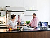 JOHN MINSHAW AND HIS WIFE IN THE KITCHEN