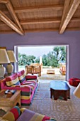 DESIGNER GINA PRICE - CORFU - VILLA ONEIRO - THE LARGE LIVING ROOM WITH SOFAS AND CHAIRS AND VIEW OUT ONTO TERRACE