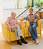 ROSE GRAY AND SCULPTOR DAVID MACILWAINE SITTING IN THEIR LIVING ROOM  LONDON