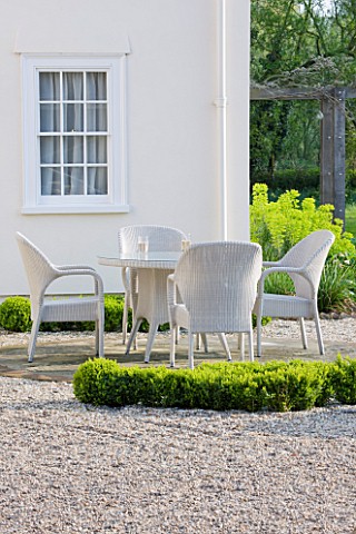 ULTING_WICK__ESSEX__SPRING_A_PLACE_TO_SIT__THE_WHITE_HOUSE_WITH_WHITE_TABLE_AND_WICKER_CHAIRS_SURROU