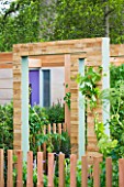 CHELSEA FLOWER SHOW 2009: MARSHALLS LIVING STREET GARDEN WITH DETAIL OF CEDAR FENCE AND CONTEMPORARY TIMBER ARCHWAY/PERGOLA