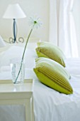 DESIGNER: CLAIRE SKINNER  ROU ESTATE  CORFU: HOUSE INTERIOR - BEDROOM IN GREEN AND WHITE. WHITE ALLIUM IN GLASS VASE - GREEN CUSHIONS AND LAMP