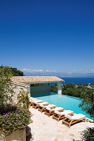 PRIVATE_VILLA__CORFU__GREECE_DESIGN_BY_ALITHEA_JOHNS__DECKCHAIRS_BESIDE_THE_SWIMMING_POOL_WITH_VIEW_