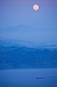 THE ROU ESTATE  CORFU: VIEW ACROSS TO ALABANIAN MOUNTAINS AND SHIP WITH MOON