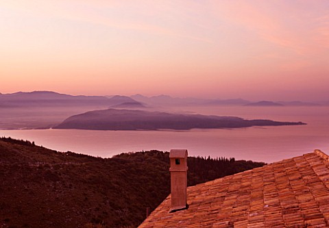 THE_ROU_ESTATE__CORFU_DAWN_VIEW_OVER_ROOFTOP_TO_SEA_AND_ALBANIAN_MOUNTAINS