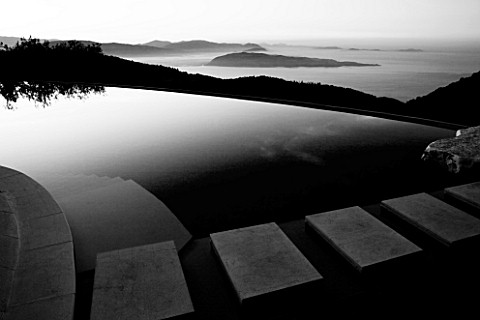 THE_ROU_ESTATE__CORFU_THE_SWIMMING_POOL_AT_DAWN_WITH_THE_ALBANIAN_MOUNTAINS_BEHIND