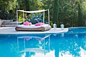 THE ROU ESTATE  CORFU: THE SWIMMING POOL WITH A WICKER SEAT WITH AWNING AND PINK CUSHIONS