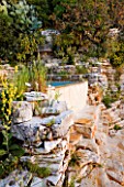 THE ROU ESTATE  CORFU: THE SWIMMING POOL AREA - ROCK FACE BESIDE THE PLUNGE POOL