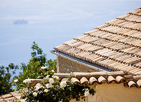 THE_ROU_ESTATE__CORFU_TILED_ROOF_WITH_SEA_AND_SHIP_BEYOND