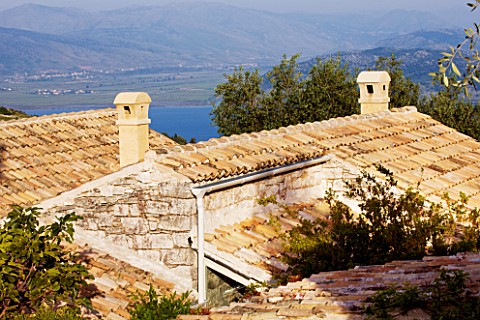 THE_ROU_ESTATE__CORFU_TILED_ROOFS_WITH_SEA_AND_ALBANIA_BEYOND