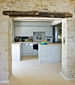 THE ROU ESTATE  CORFU: KITCHEN WITH STONE WALLS AND BEAM AND LIMESTONE TILED FLOOR
