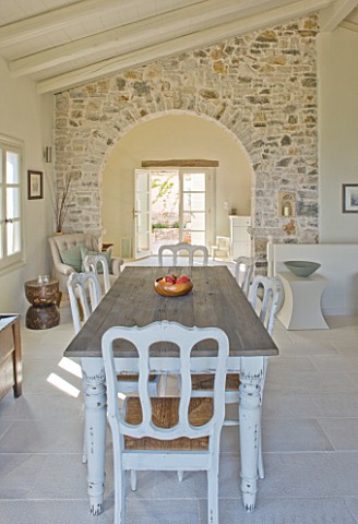THE_ROU_ESTATE__CORFU_DINING_AREA_WITH_TABLE_AND_CHAIRS_AND_STONE_WALL