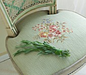 THE ROU ESTATE  CORFU: INTERIOR DETAIL OF UPHOLSTERED CHAIR WITH POSY