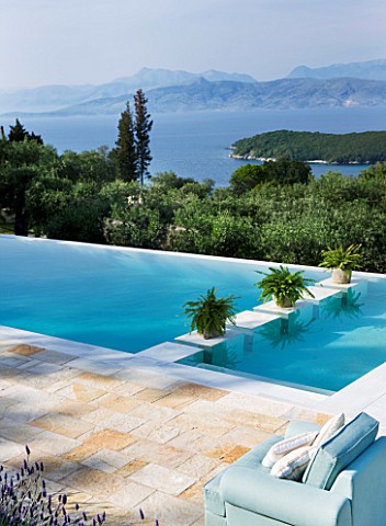 THE_KAPARELLI_ESTATE__CORFU__PATIOSEATING_AREA_WITH_VIEW_OVER_SWIMMING_POOL_OUT_TO_SEA_WITH_ALBANIAN