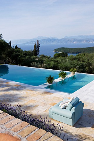 THE_KAPARELLI_ESTATE__CORFU__VIEW_OVER_SWIMMING_POOL_OUT_TO_SEA_WITH_ALBANIAN_MOUNTAINS_BEYOND
