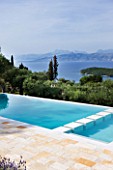 THE KAPARELLI ESTATE  CORFU - VIEW OVER SWIMMING POOL OUT TO SEA WITH ALBANIAN MOUNTAINS BEYOND