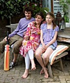 JOA STUDHOLMES LONDON HOME: JOA AND HER TWO CHILDREN RELAX ON A BENCH IN THE GARDEN