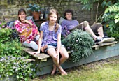 JOA STUDHOLMES LONDON HOME: JOA AND FAMILY RELAX IN THEIR GARDEN