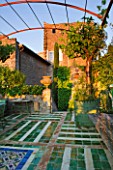 LA CARMEJANE, FRANCE: LUBERON, PROVENCE, TERRACE, PATIO WITH TERRACOTTA CONTAINERS, CLIPPED, TOPIARY, GREEN, GLAZED, TILES, VINES, TOWER, FRENCH, COUNTRY, GARDEN