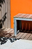 DESIGNERS WYNNIAT- HUSEY CLARKE: MODERN  CONTEMPORARY GARDEN IN BRIGHTON WITH DECKING  ORANGE PANEL ON WALL  WOODEN BENCH  AND REFLECTIONS