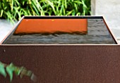 DESIGNERS WYNNIAT- HUSEY CLARKE: MODERN  CONTEMPORARY TOWN GARDEN IN BRIGHTON - SQUARE METAL WATER FEATURE WITH SHADOW/ REFLECTION OF ORANGE PANEL ON WALL