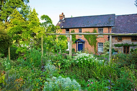 MOORS_MEADOW_GARDEN__NURSERY__HEREFORDSHIRE_THE_HOUSE_SEEN_FROM_THE_HERB_GARDEN