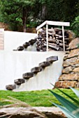 DESIGNER: JEAN-LAURENT FELIZIA  FRANCE: WOODEN STEPS UP A WHITE WALL UP TO A WOOD STORE