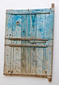 DESIGNERS ERIC OSSART AND ARNAUD MAURIERES  MOROCCO: AL HOSSOUN - FADED BLUE WOODEN DOOR SCULPTURE ON WALL