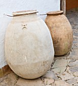 DESIGNERS ERIC OSSART AND ARNAUD MAURIERES  MOROCCO:  AL HOSSOUN - TERRACOTTA JARS/ CONTAINERS AGAINST A WALL