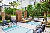 ROOF GARDEN BY STEPHEN WOODHAMS, LONDON: TERRACE/SEATING AREA WITH WOODEN BENCHES, BOX BALLS IN CONTAINERS, DECKING WITH FROSTED GLASS SKYLIGHTS, SCREEN, MIRROR, PLEACHED HORNBEAMS, DECKS, DECKING, DECKED